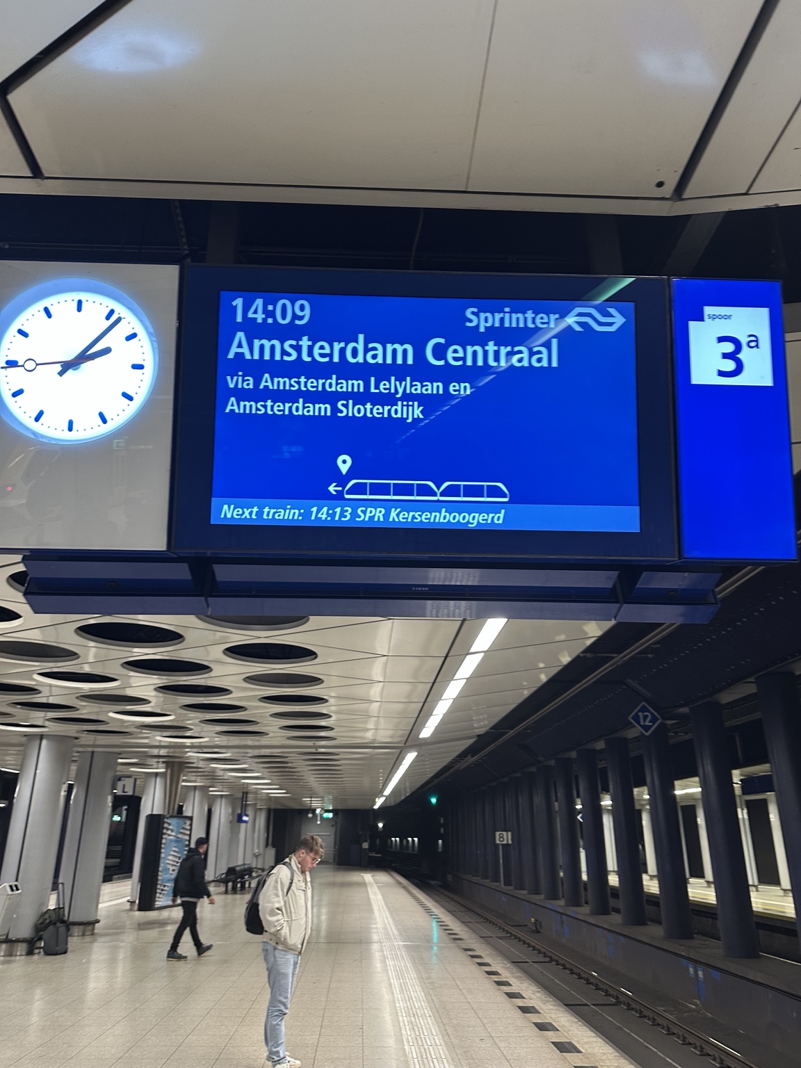 A railway departure board showing Amsterdam Centraal