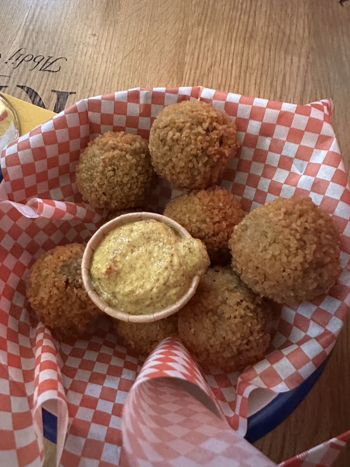 A basket of bitterballen with mustard