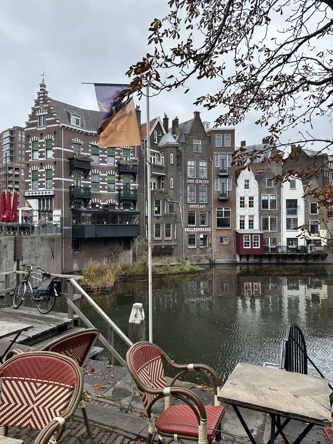 Historic buildings reflected in a quiet Rotterdam waterway