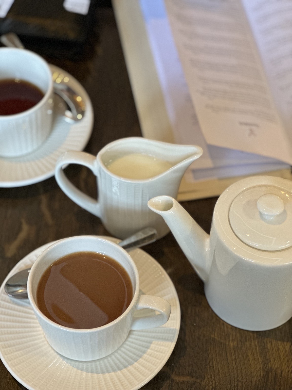 A white teapot, cups and milk at Glenfiddich